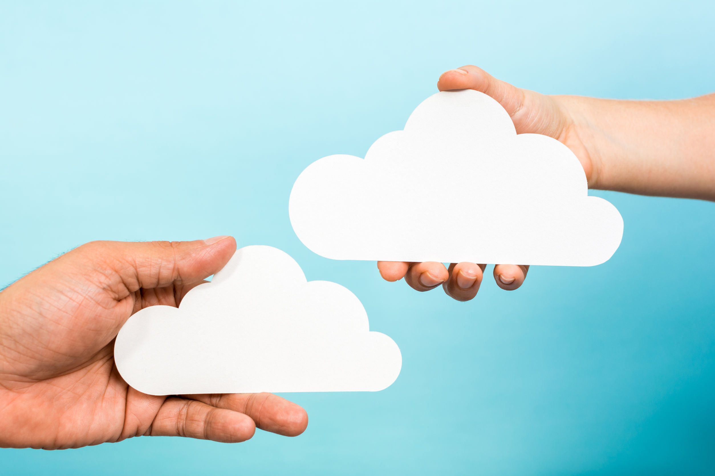 saas company portrayed as hands holding clouds