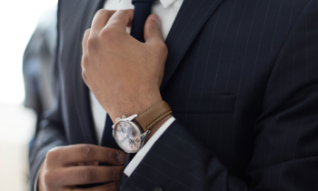 man straightening a tie