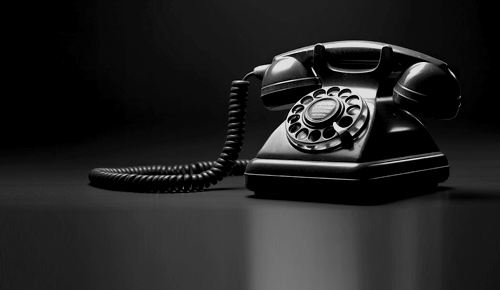 Photo of a vintage black rotary-style landline phone taken by Pawel Czerwinski